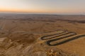 Sunrise view of winding road and Makhtesh Ramon, Negev Desert
