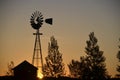 Sunrise with windmill and barn silhouette Royalty Free Stock Photo