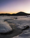 Sunrise in the winter mountain. Bottom of the empty lake Shiroka poliana in Rhodope mountain, Bulgaria.