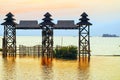 Sunrise wooden arch in Golden Lake at Inle Lake, Myanmar.