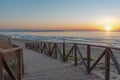 Sunrise on the wooden boardwalks of the beach