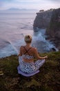 Sunrise yoga. Young woman practicing Padmasana, Lotus Pose. Seated asana. Hands in gyan mudra. Self-care concept. Yoga retreat.