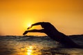 Sunrise, young man swiming in the sea Royalty Free Stock Photo