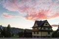 Sunrises over quaint country home beside fence