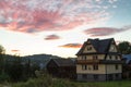 Sunrises over quaint country home beside fence