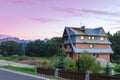 Sunrises over quaint country home beside fence