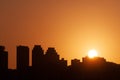 Sunrising behind a silhouette of a skyline Royalty Free Stock Photo