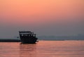 Sunrising behind a traditional fishing dhow Royalty Free Stock Photo