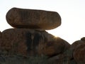 The suns rays appear over a unusual rock at the devil`s marbles in australia Royalty Free Stock Photo