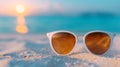 Sunscreen Lotion and Sunglasses on Sandy Beach Background Royalty Free Stock Photo