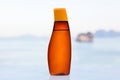 Sunscreen in luxurious bottle on beach.