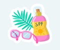 Sunscreen in pink bottle, sunglasses and palm leaf. Summertime rest