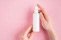 Sunscreen protection concept. Top above overhead pov first person close up view photo of female hands holding white spray bottle Royalty Free Stock Photo