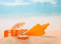 Sunscreen and shell with pearl in the Golden sand Royalty Free Stock Photo