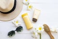 Sunscreen spf50 cosmetics beauty makeup for skin face with body lotion, comb, hat and flower frangipani of lifestyle woman relax Royalty Free Stock Photo