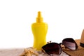 Sunscreen spray bottle and summer straw hat beach shoes and sunglasses against white copy space. Summer vacation banner Royalty Free Stock Photo