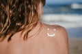 Sunscreen sun drawing lotion on suntan back relaxing tanning at the beach. Woman sitting and relaxing with a smiling shape face Royalty Free Stock Photo