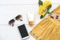 Sunscreen ,sunglasses ,mobile phone and yellow embroider cloth of lifestyle woman relax