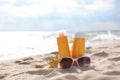 Sunscreens on the beach near the sea close up Royalty Free Stock Photo