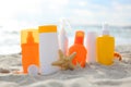 Sunscreens on the beach near the sea close up Royalty Free Stock Photo