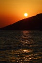 Sunset above bay and foothill of surrounding mountains near Paklenica, Croatia