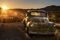Sunset above car wrecks in the Mojave desert on historic route 66