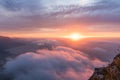 Sunset above the clouds on Lions Head in Cape Town South Africa with the sea in the background Royalty Free Stock Photo