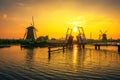 Sunset above a historic drawbridge and old windmills in Kinderdijk, Netherlands