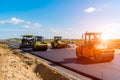 Sunset above the road roller working on the construction site Royalty Free Stock Photo