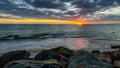 Sunset above the sea on a rocky beach Royalty Free Stock Photo