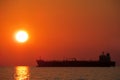 Sunset above the sea, ship silhouette Royalty Free Stock Photo