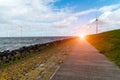 Sunset above windmills in the ocean Royalty Free Stock Photo