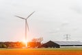 Sunset above the windmills on the tulip field Royalty Free Stock Photo