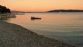 Sunset on the Adriatic Sea in Croatia, Kastel Luksic. View from the beach to the sea. Split city, mountains and yacht.