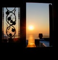 Sunset in the aegean sea from a house. Santorini island Greece.