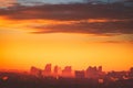 Sunset aerial Europe town silhouette: Kyiv cityscape at sun set golden tone with cloudy sky, Ukraine