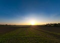 Sunset aerial view: Aerial Journey Over a Tranquil Farm Field