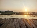 sunset in the afternoon of Central Java on the edge of the pool and wooden planks are good for seating Royalty Free Stock Photo