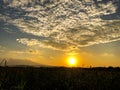 Sunset in the afternoon with the sun setting over the expanse of the desert