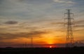 Sunset against high electric voltage pole