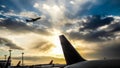 Sunset in the airport with a tail and an airplane takeoff