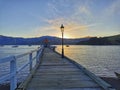 Sunset at Akaroa harbour pier with an old street light. New Zealand. Royalty Free Stock Photo