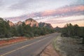 Sunset on highway with view of Sedona red rock formations in Arizona, USA