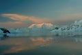 Sunset and alpenglow, mountains and mirror - calm ocean