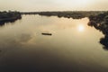 Sunset on the Amazon river. Boat with people on the water.