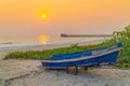 Sunset at anchor fishing boat at low tide Royalty Free Stock Photo