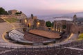 Sunset on the ancient roman-greek amphitheater with the Giardini Naxos bay in the back in Taormina, Sicily, Italy Royalty Free Stock Photo