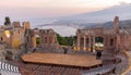 Sunset on the ancient roman-greek amphitheater with the Giardini Naxos bay in the back in Taormina, Sicily, Italy Royalty Free Stock Photo