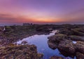 Sunset as seen from Mengening Beach, Bali,Indonesia. Mossy rocks