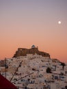 sunset in Astypalaia with the full moon rising and a red windmill in the foreground